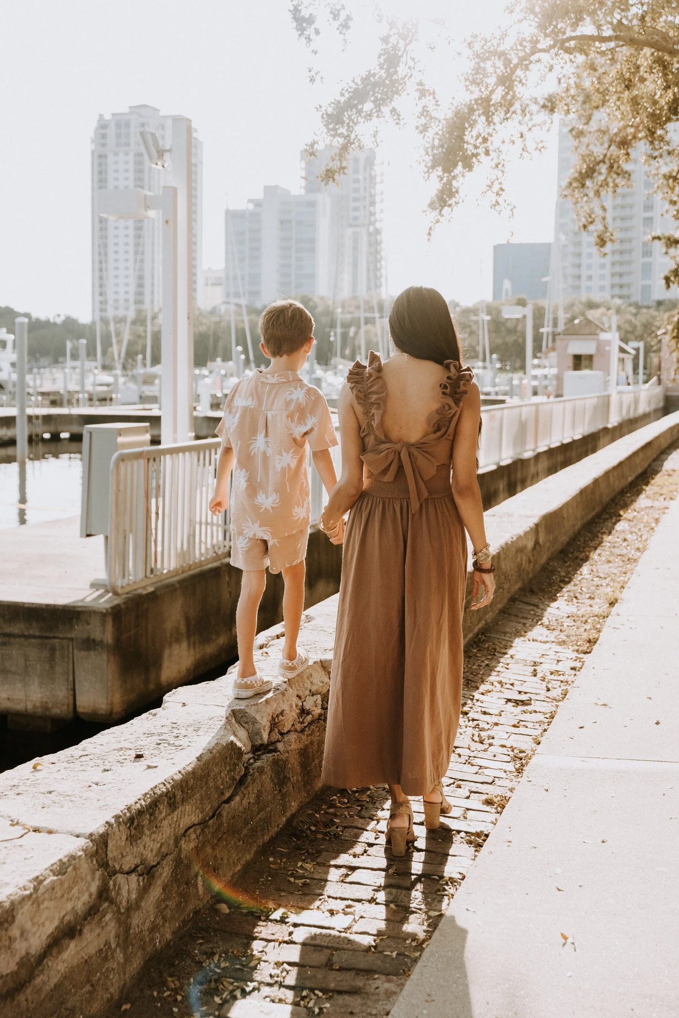 Aneesa and her son walking together by the marina